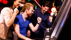 AdobeStock_83146659-Young-people-in-the-casino-slots